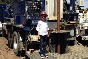 never too young to learn - young child at a drilling site